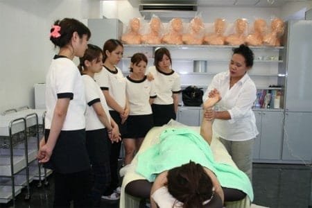 Ibu Indri practicing with students at Ryubi International Beauty College in Okinawa Japan.